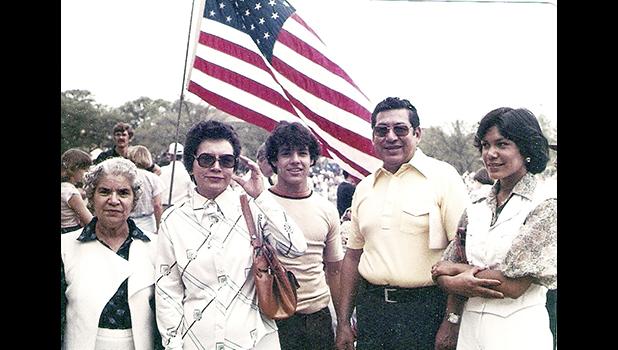 In this 1970s photo provided by Russell Contreras, Ciprian Contreras, second from right, with sunglasses in a yellow shirt, a World War II-era U.S. Marine, attends a July Fourth celebration with his family in Houston. In an essay, Associated Press writer Russell Contreras says the July Fourth holiday as a Mexican American has always troubled him because of his family's history in the U.S. But remembering his Uncle Ciprian Contreras' heroics as a U.S. Marine at Iwo Jima in 1945, makes him look at America's Independence Day differently. (Courtesy of Russell Contreras via AP) Ciprian Contreras, second from right, with sunglasses