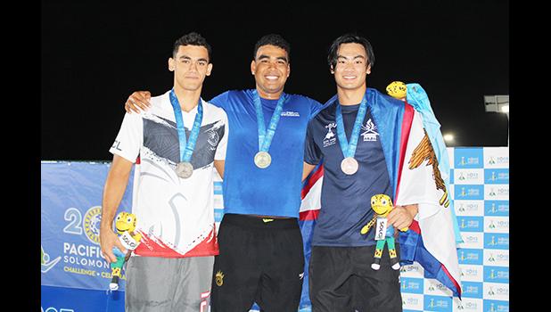 Micah Masei with Tasi Limtiaco of the Federated States of Micronesia (center) and silver medalist Alexandre Gane of New Caledonia