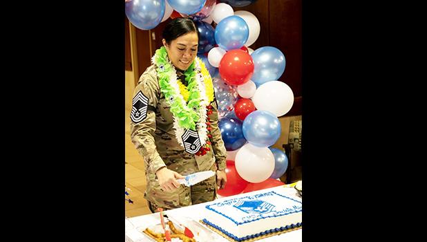 Chief Master Sergeant Jacinta Migo cutting her cake