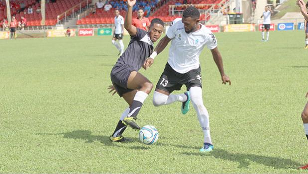 Milo Tiatia (left) of American Samoa battles for possession