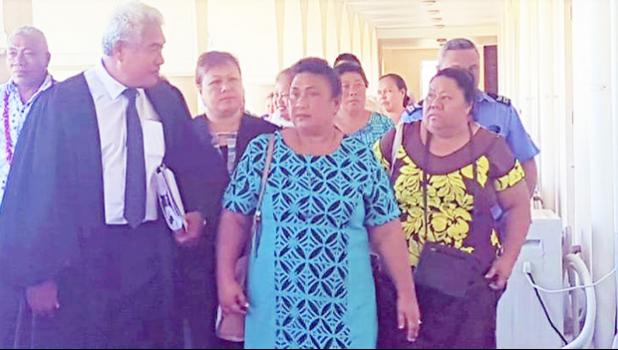Leutogi Te'o (C) and Luse Tauvale (R) talking to their lawyer