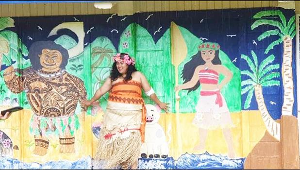 American Samoa’s very own “Moana” — standing in front of classroom doors painted with the likeness of Disney’s Maui and Moana