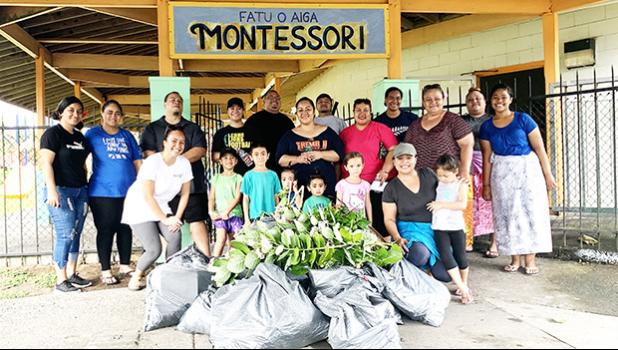 Faculty and parents of Fatuoaiga Montessori School pose for a photo after an hour of picking up trash