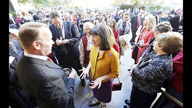 Kate Kelly, center, founder of Ordain Women, with a group of more than 150 women denied entrance to an all-male meeting of Mormon priesthood holders in Oct. 2013. (Rick Bowmer/ AP) Kate Kelly, center, founder of Ordain Women