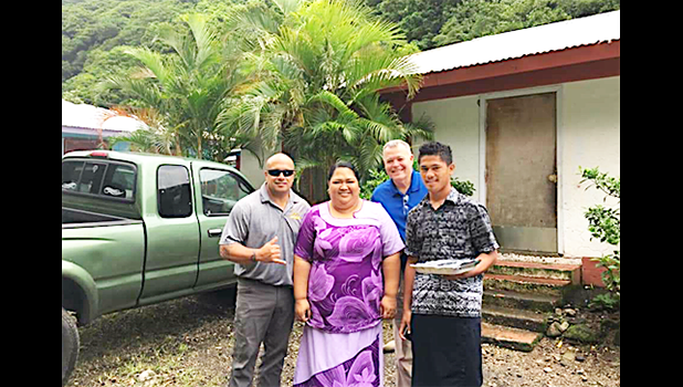 Mrs. Asoiva Togafau (center), with John and Ricky Leulu (far right)