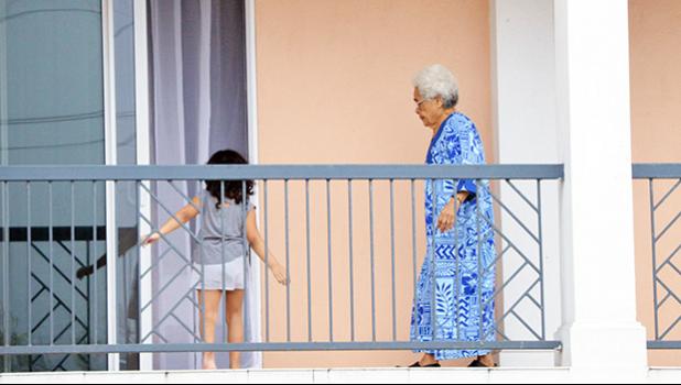 A woman and a young child on a balcony at Tradewinds Hotel