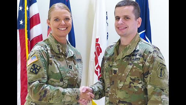 Cpt. Carneen Cotton (left) shaking hands with Capt. Timothy Shea