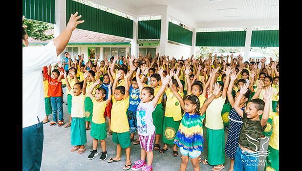 Students at Lauli`i Elementary School with a NMSAS staff member