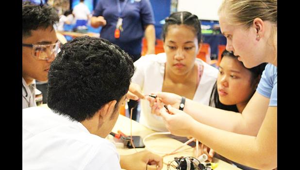 Pictured are some students from Samoana HS getting advice from a visiting Michigan student on starting their own underwater robotics teams.