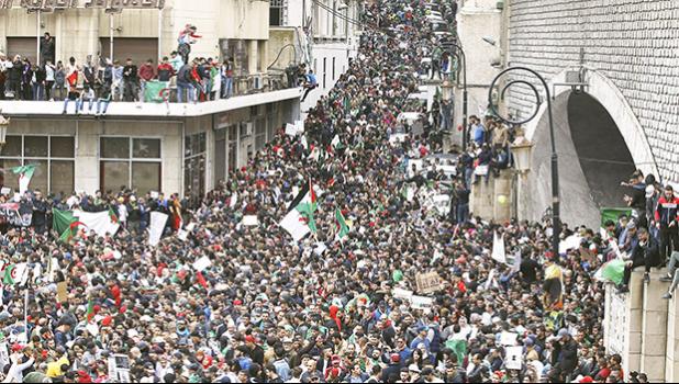 In this Friday, March 8, 2019 file photo, people gather for a demonstration in Algiers to protest President Abdelaziz Bouteflika's hold on power. On Friday, May 3, 2019, The Associated Press has found that a video from these March 8 protests circulating on the internet is incorrectly described as Muslims attacking Danish police van in Copenhagen. The video shows a side demonstration elsewhere in the capital. (AP Photo/Fateh Guidoum) people gather for a demonstration in Algiers to protest President Abdelaziz Bouteflika's hold on power.