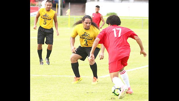 Pago Youth’s striker, Rambo Tapui defending against a Veitongo FC player that was threatening to shoot from a distance during the second half of their match up last Saturday evening – Pago Youth and Veitongo FC were tied, 1 - 1. [photo: TG]
