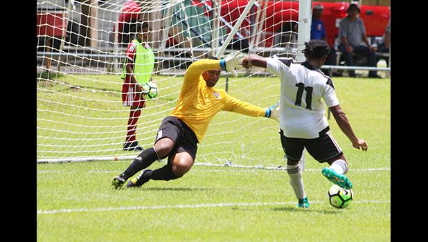 Maro Bonsu-Maro charging up for his third goal of the match as Veitongo FC goalie Sione Uhatahi reacts to defend a hat-trick that came in the second half of their 9-2 victory over Tonga this past Tuesday. All tourney games are played at the Pago Soccer Field. [photo: TG]