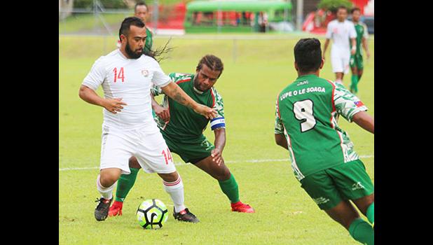 Suliasi Lauhoua (14) of Veitongo FC trying to defend against Michael Fifi’i of Lupe ole Soaga during the opening half of their match up last Friday afternoon. Veitongo FC lost 6 - 0 against the Samoans. [photo: TG]