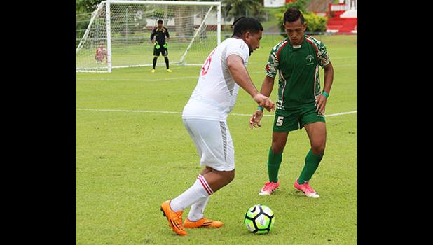 Vaaina Tualau of Veitongo FC trying to maneuver his way around Tauati Tanoai of Lupe ole Soaga during the second half of their match last Friday. Lupe ole Soaga defeated Veitongo FC 6 - 0. [photo: TG]