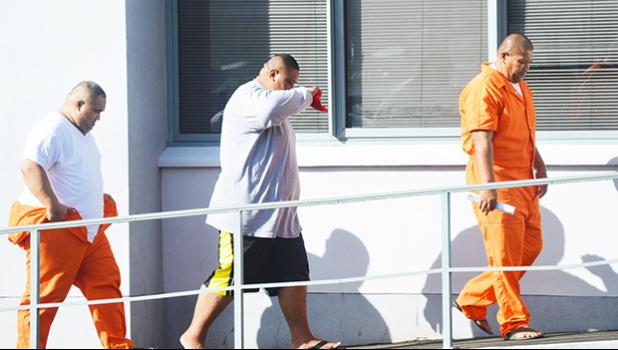 Three of the four DPS officers, who were assigned to the Juvenile Detention Center, heading into the District Court last Friday morning for their initial appearance after being arrested last Thursday for alleged illegal activities at the Center. The officers are seen in this photo without handcuffs, however, they were in handcuffs during their court appearance. [photo: AF]