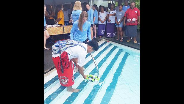 OJ Bartley of Faga'itua High School getting his hands and feet wet