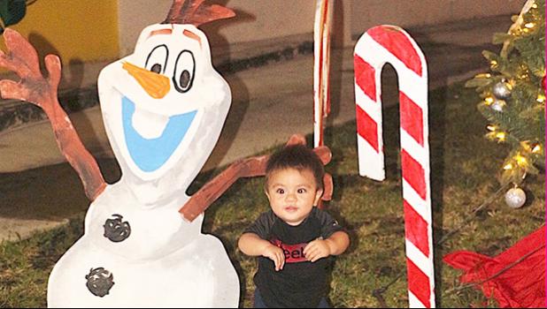 Child laughing as he sees the cartoon character Olaf 