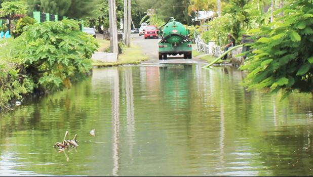 Pumper truck pumping out water at Fatuoaiga/Ottoville road