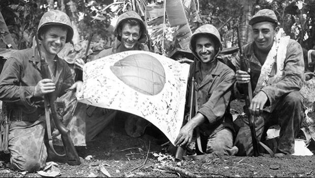 Trophy: U.S. troops hold a Japanese flag captured in July 1944 during the Battle of Saipan