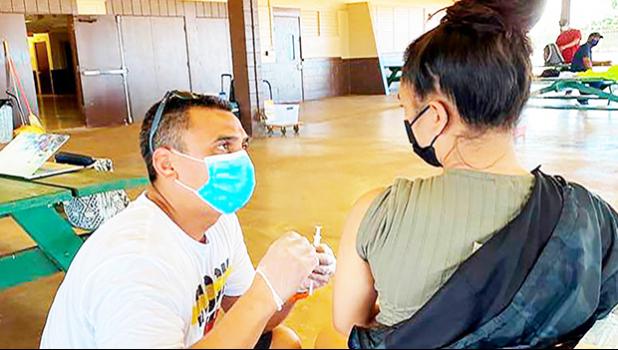 Dr. Kapono Chong-Hanssen administers COVID-19 vaccines