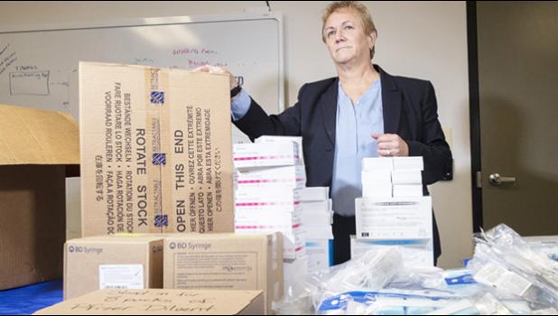 Official with vaccine kits