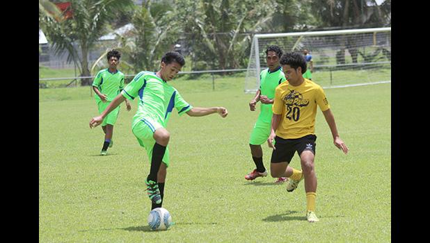 A Taputimu Youth player tries to control the ball 
