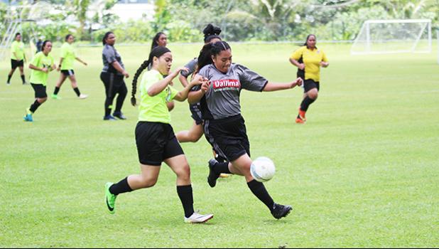 A Pago Youth player challenges a Taputimu Youth defender
