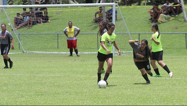 A Pago Youth player controls the ball against a Taputimu defender