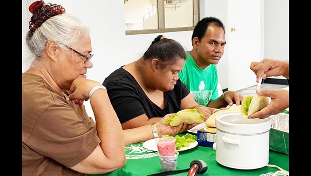 Parents with their special needs children learning how to make tacos