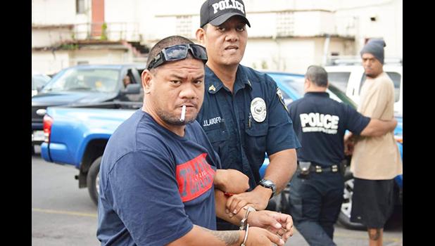 Defendant, Pati Lepou with a police officer 