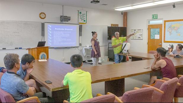 Translator Program Manager Autagavaia Tunai Alfred Peters explain proper pesticide disposal procedures