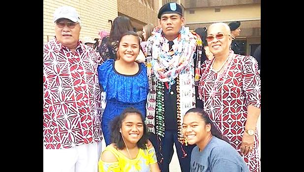 Pfc. Washington Pou Ameperosa stands for a picture with three sisters and his grandparents 