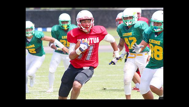 Vito Kitiona carrying this one for a huge gain for Faga’itua during their varsity play-off match against the Lions last Friday morning. The Vikings defeated Leone 20 - 18 to return to ASHSAA’s Championship title game to defend their title – against the Warriors this Saturday. [photo: TG]