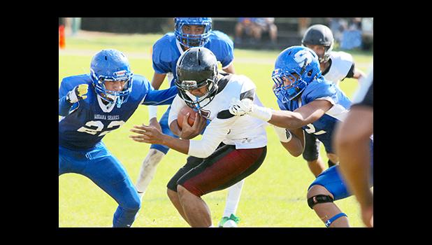 Tafuna Warriors Puletu Fono bracing for impact as he is moments away from being ‘sandwiched’ by two Shark defenders in the first half of their varsity play-off game. Fono recorded two touchdown catches as he led the Warriors to a 14 - 6 victory. [photo: TG]