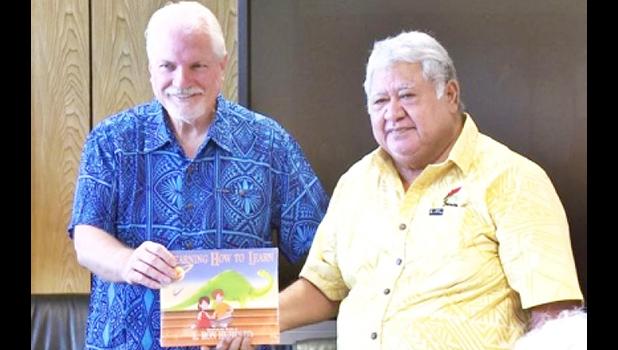 Samoan PM Tuilaepa Sailele receiving a textbook from Applied Scholastics ambassador Warren Meyer