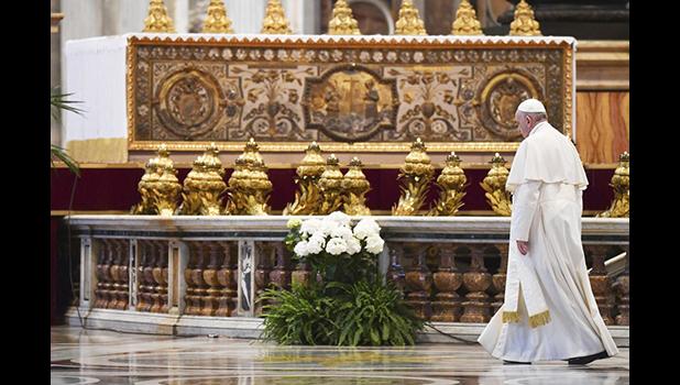 Pope Francis leaves at the end of Easter Sunday Mass inside an empty St. Peter's Basilica, at the Vatican, Sunday, April 12, 2020. Pope Francis and Christians around the world marked a solitary Easter Sunday, forced to celebrate the most joyful day in the liturgical calendar amid the sorrowful reminders of the devastation wrought by the coronavirus pandemic. The new coronavirus causes mild or moderate symptoms for most people, but for some, especially older adults and people with existing health problems, it can cause more severe illness or death. (Andreas Solaro/Pool Photo via AP) Pope Francis leaves at the end of Easter Sunday Mass