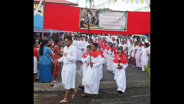 The start of the procession of worshiper from the Holy Family Parish in Fatuoaiga