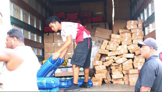 Red Cross Volunteers hard at work at some of the Red Cross Point of distribution centers at the West side of the island over the weekend. At some PODs, frustrated residents, verbally abused volunteers, after standing in long lines only to find out that their names were not on the list. Residents were given phone numbers instead of supplies and told to contact the EOC to have their homes assessed and put on a list for emergency supplies. [Photo: THA]