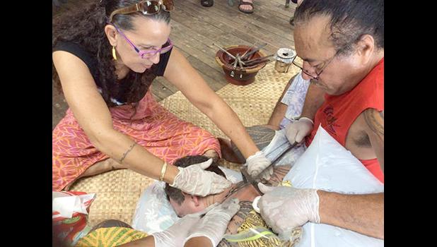 Master Tufuga Su’a Tupuola Fitiao practicing his art, assisted by ASCC Fine Arts Professor Regina Meredith Fitiao who is also his wife