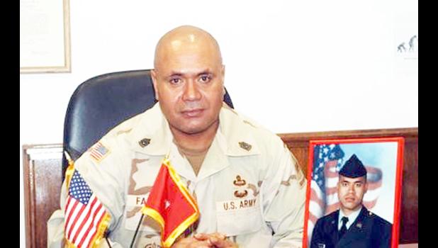 CSM retired Faleniko with a photo of his son, Jonathan.