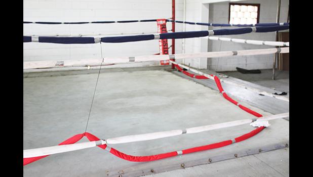 Ring rope cut and laying on floor of boxing ring