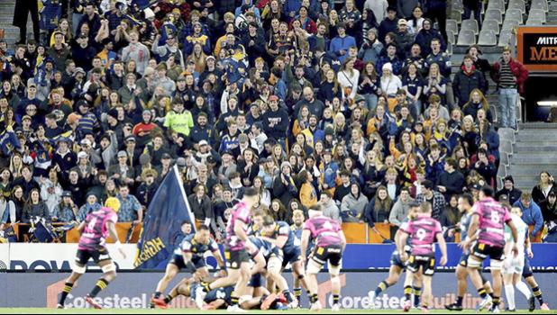 Rugby match in New Zealand with fans in the stands