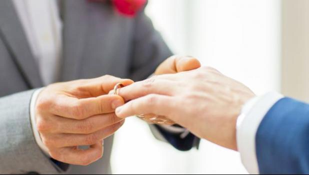 (stock photo: RNZI) Hands of two men exchanging rings