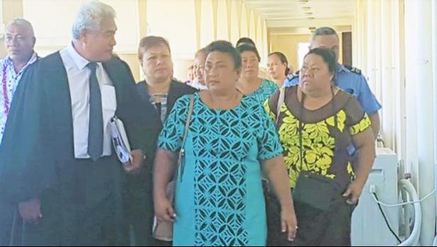 Leutogi Te'o (C) and Luse Tauvale (R) talking to their lawyer
