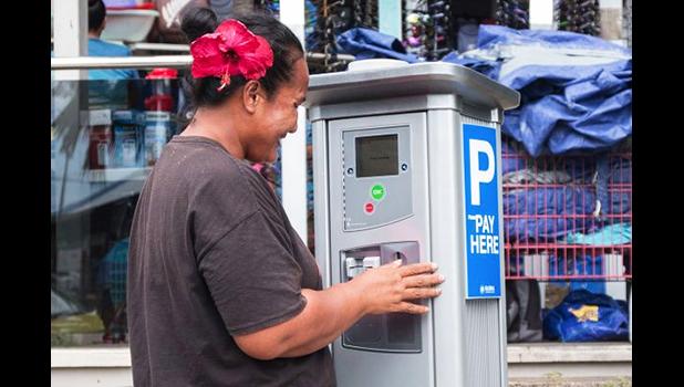  A member of the public takes a closer look at one of the parking meters