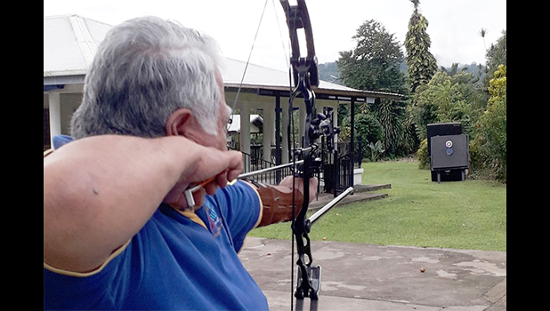 Samoan Prime Minister Tuilaepa Aiono Sailele Malielegaoi aiming to shoot an arrow