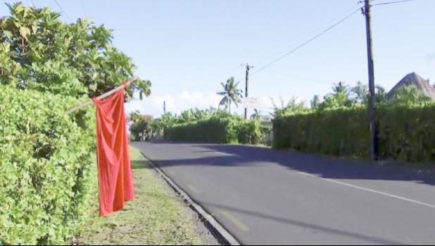 n this image from video, a red flags hangs outside homes of residents who have not been vaccinated in Apia, Samoa, Thursday, Dec. 5, 2019. Samoa’s main streets were eerily quiet on Thursday, as the government stepped up efforts to curb a measles epidemic that has killed 62 people. (TVNZ via AP) Empty street in Apia with red flag outside a yard.