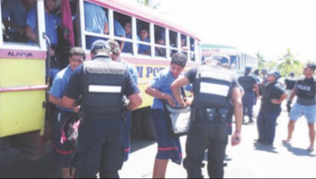 Catholic Education director, Father Mikaele Tuimavave, has appealed to students to stop the violence. (Photo: Supplied) Police talking to students near school bus.