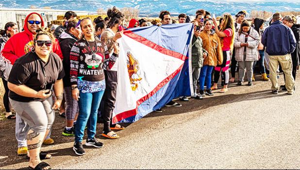 American Samoan workers at the turkey plant in Moroni holding America Samoa flag