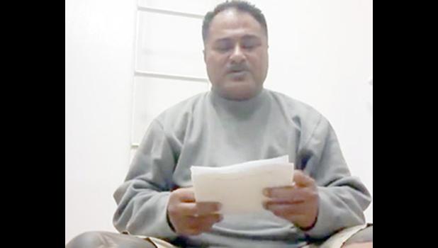 Samoa sailor, Puletiu  holds up a paper from his employer